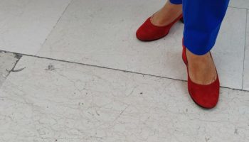 Woman in bright blue trousers, a color idea for a leather jacket and cobalt trousers outfit