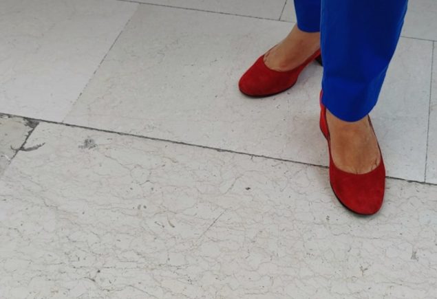Woman in bright blue trousers, a color idea for a leather jacket and cobalt trousers outfit