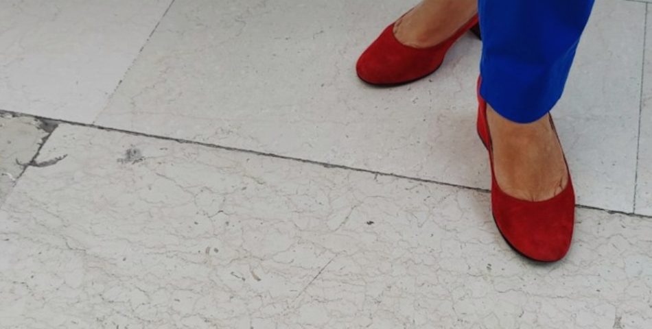 Woman in bright blue trousers, a color idea for a leather jacket and cobalt trousers outfit