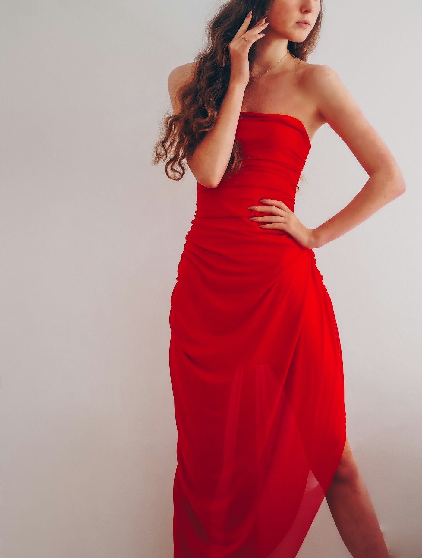 Woman wearing a red strapless tube dress