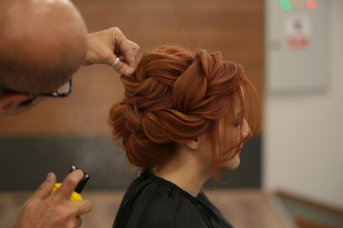 Stylist finishing a party hairstyle