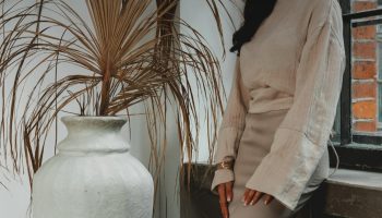 Woman in a tonal neutral outfit styled in cream and beige tones