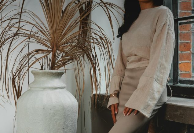 Woman in a tonal neutral outfit styled in cream and beige tones