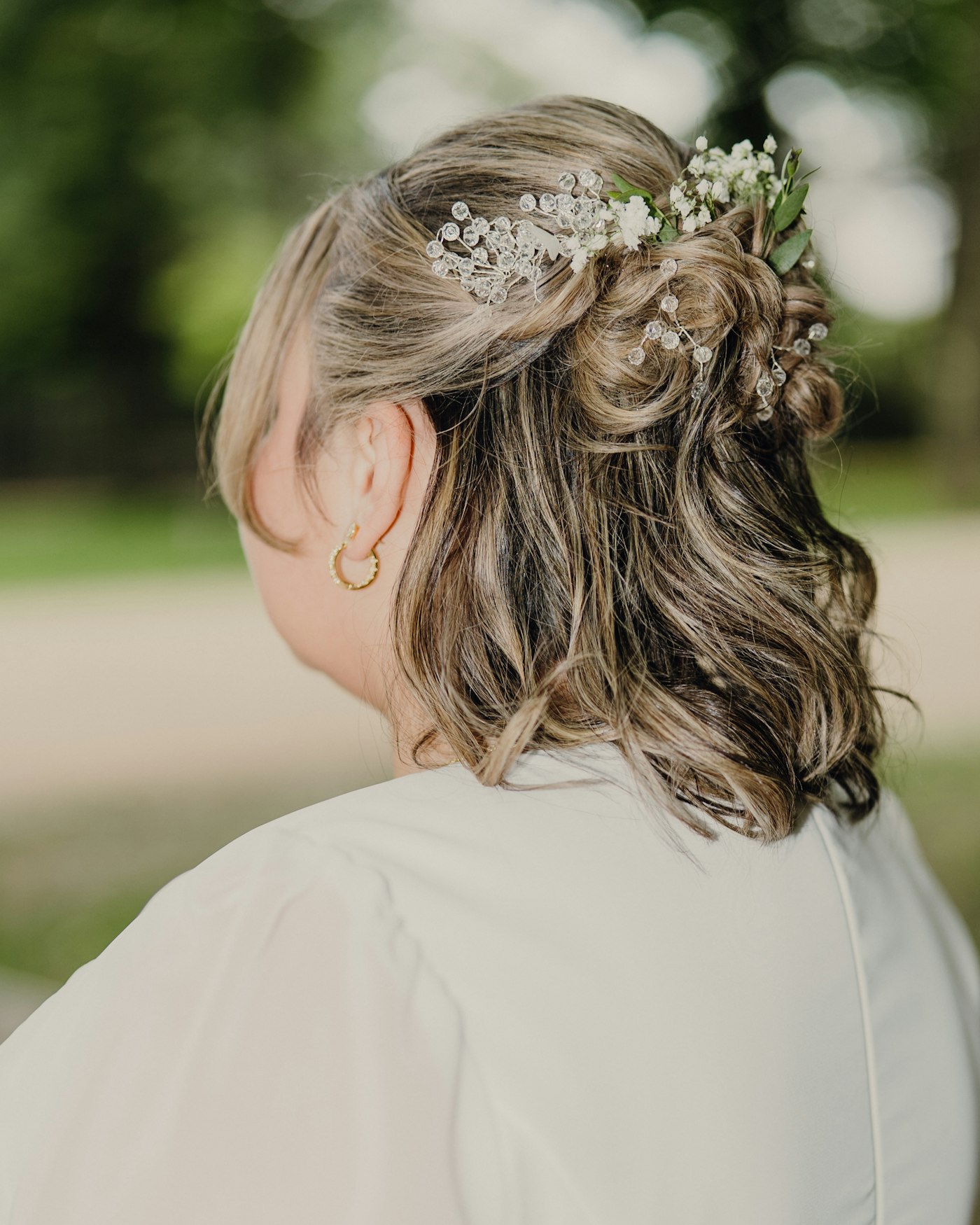 Woman with a floral hair accessory and gold earring