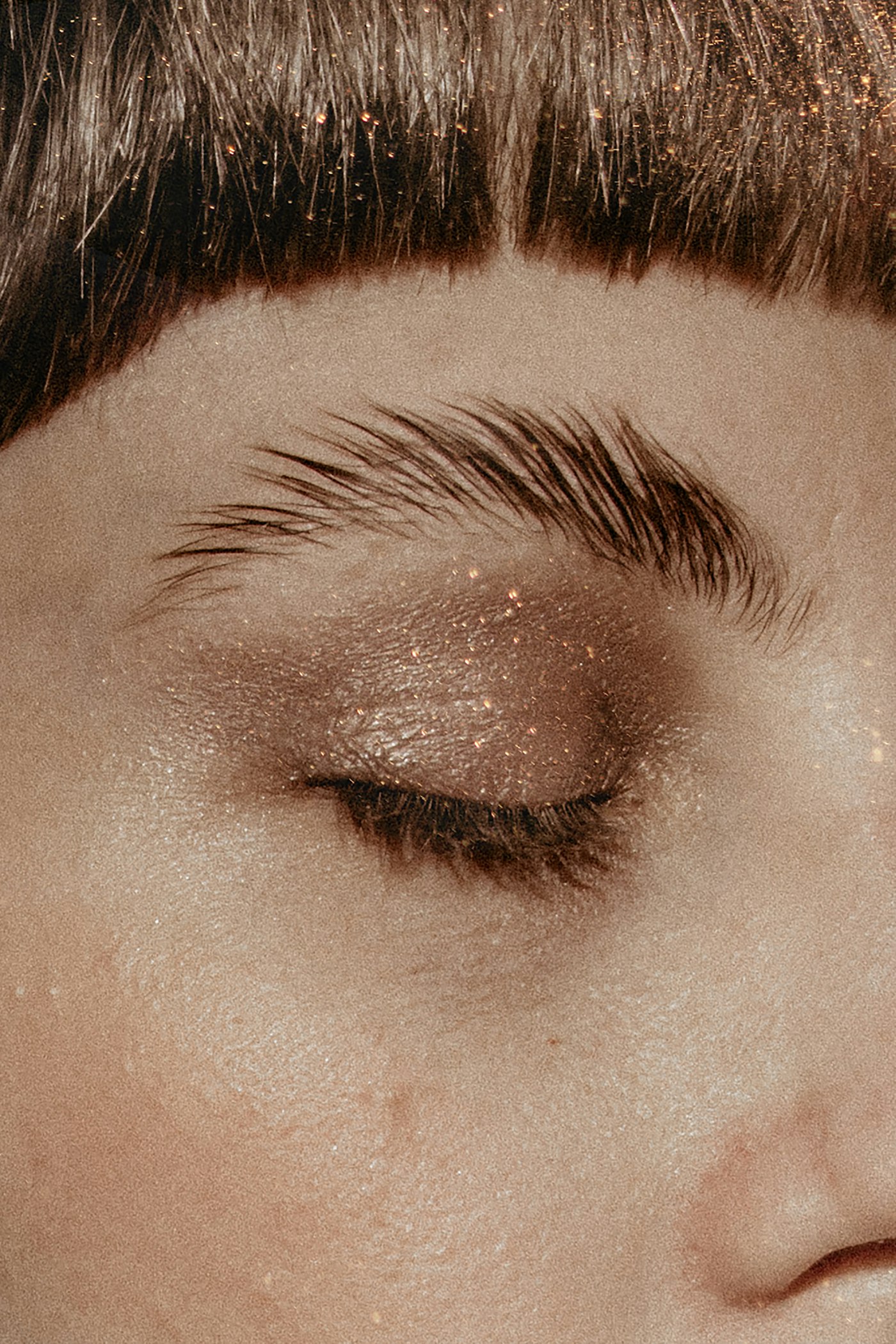 Close up of an eye with champagne glitter on the lid