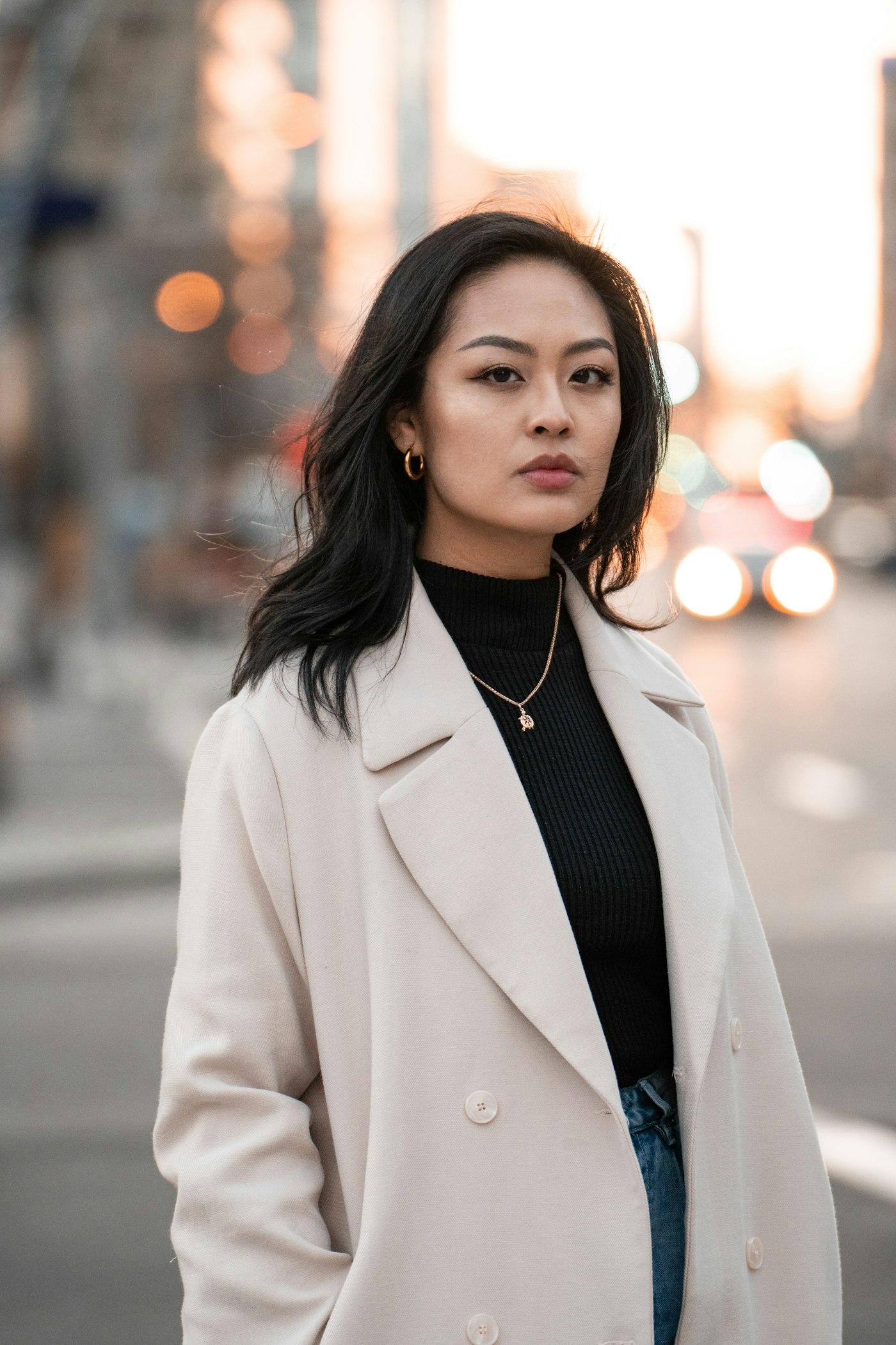 Woman in a white blazer standing on a road