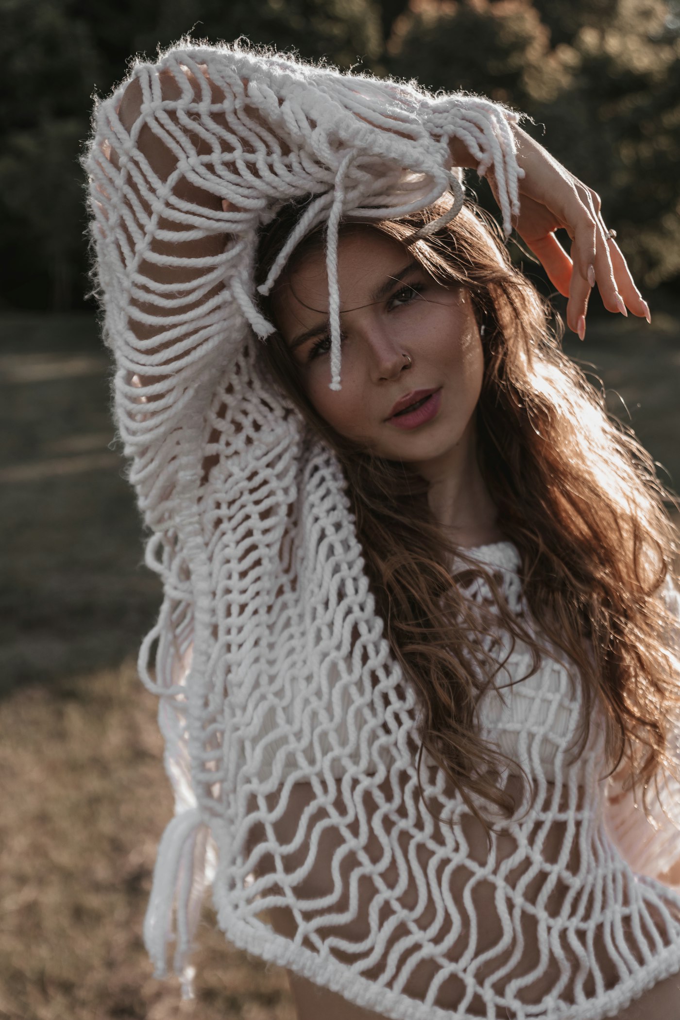Woman with long hair wearing a white crochet top