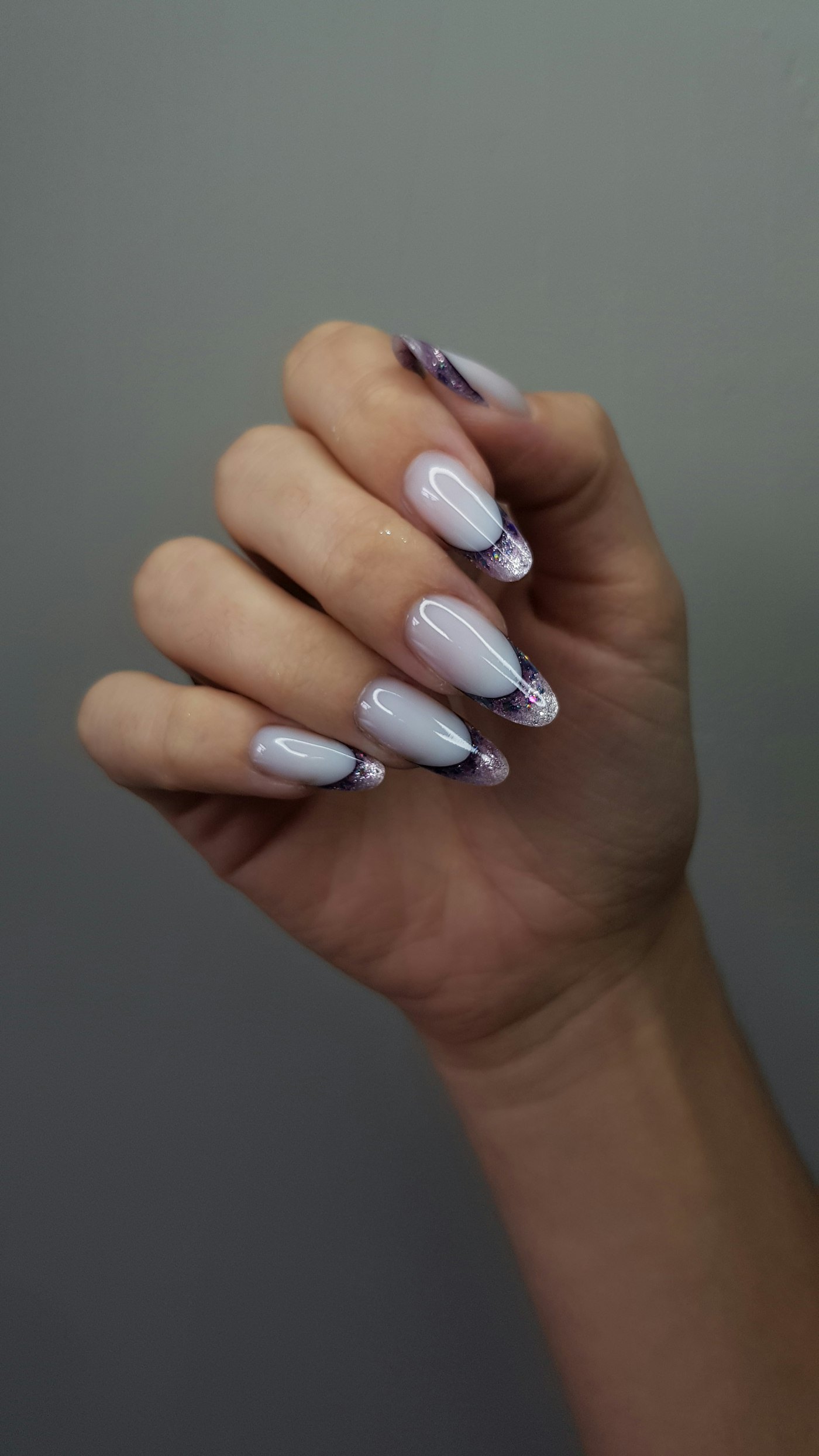 Elegant white nails with purple and black marbled tips