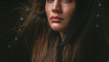 Woman with long glossy brown hair, winter hair colour inspiration