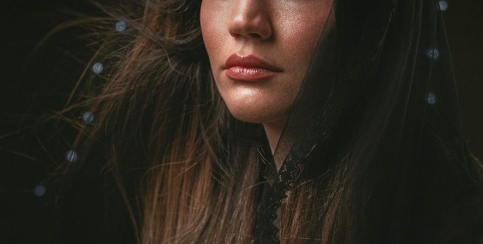 Woman with long glossy brown hair, winter hair colour inspiration